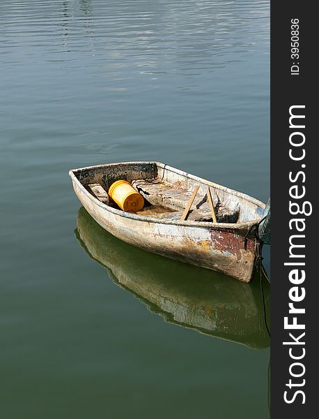 A small dinghy boat bobbing on calm waters