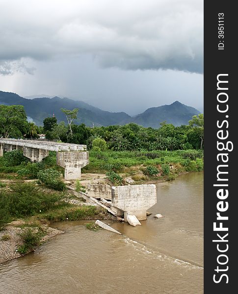 An old bridge in Honduras destroyed by flood waters. An old bridge in Honduras destroyed by flood waters