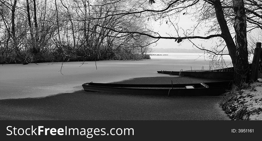 Small boats in a frozen lake. Small boats in a frozen lake