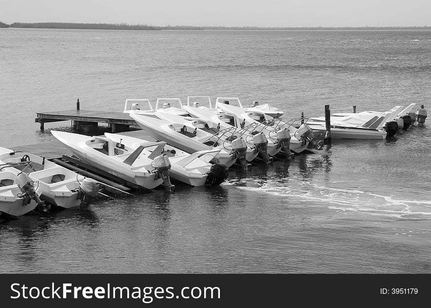 Boats docked at a marina in black and white. Boats docked at a marina in black and white