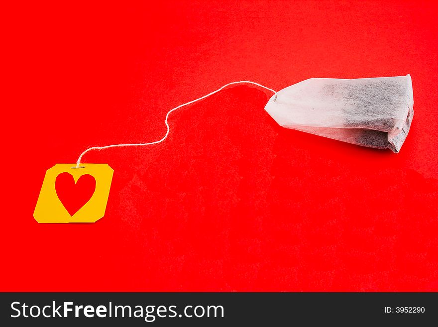 Tea-bag Isolated On A Red Background With Heart