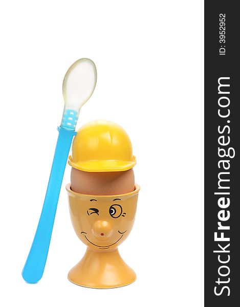 Smiling eggcup with a helmet and the blue spoon