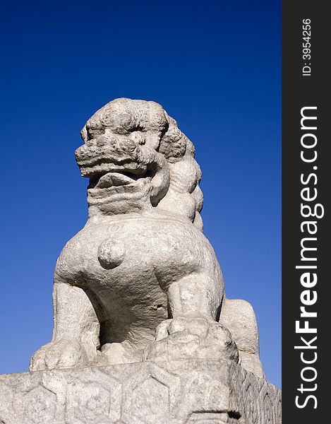 Stone lion under blue sky