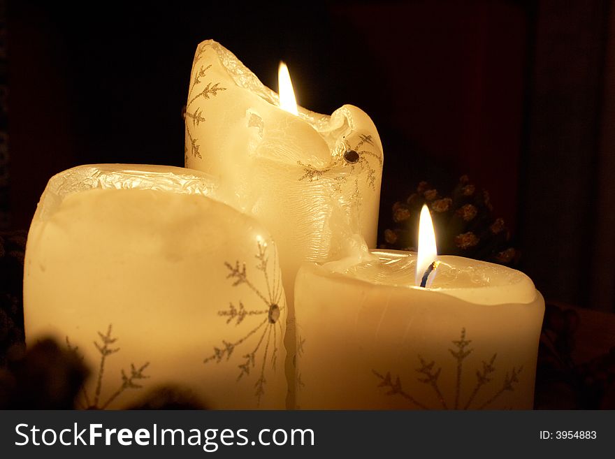 A trio of Xmas candles cutting through the darkness