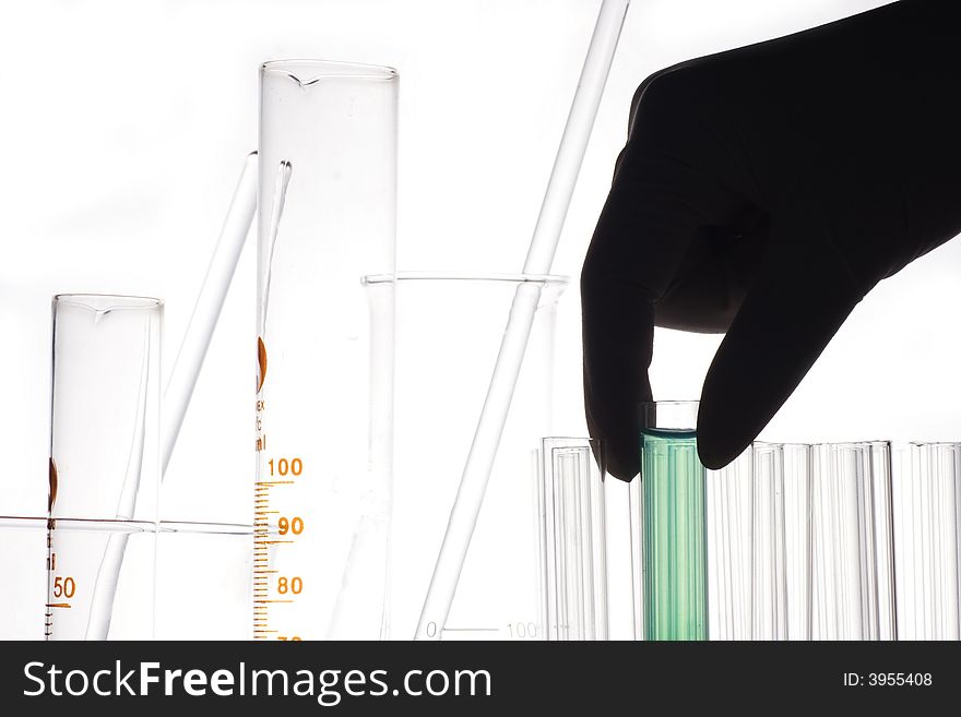 A hand holding a test tube in plain background. A hand holding a test tube in plain background.