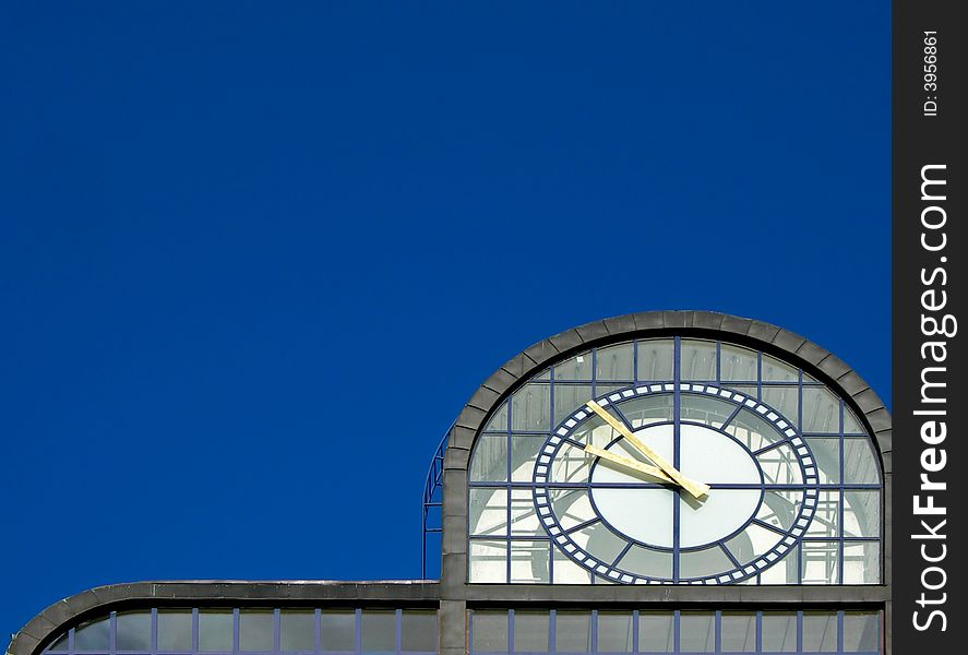 Modern clock tower in Prague against the blue sky