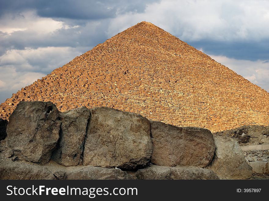 Scene of the egyptian pyramid on background cloudy sky