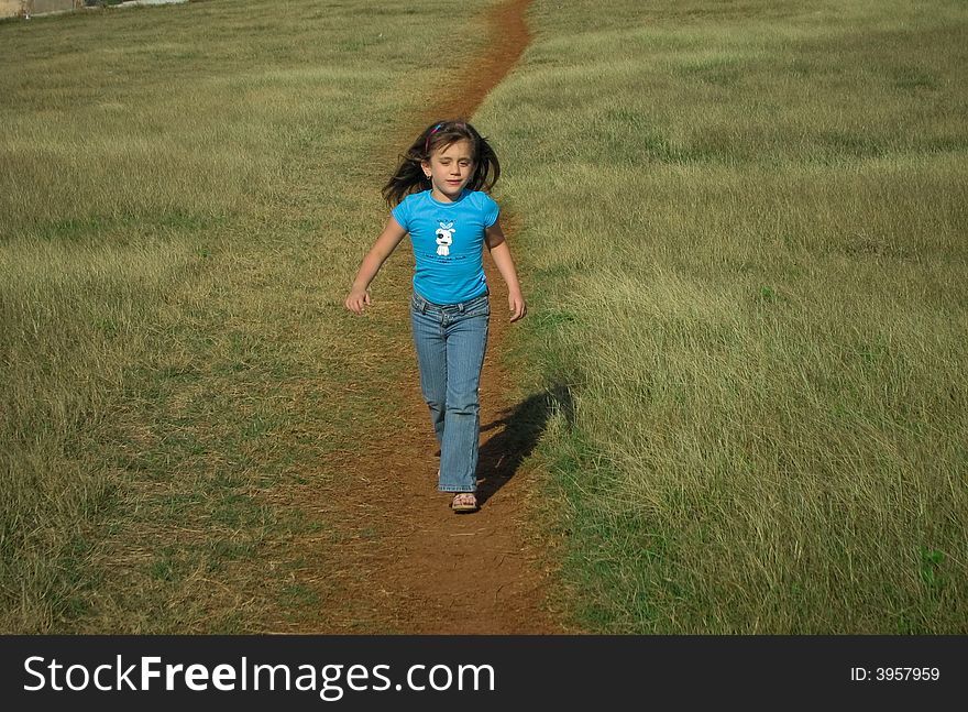 Beautiful girl running in the country