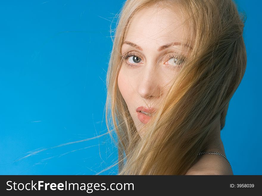 Portrait  woman breeze hair on blue background