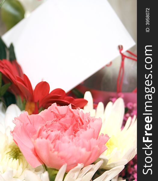 Blank card on a bouquet of flowers. Blank card on a bouquet of flowers