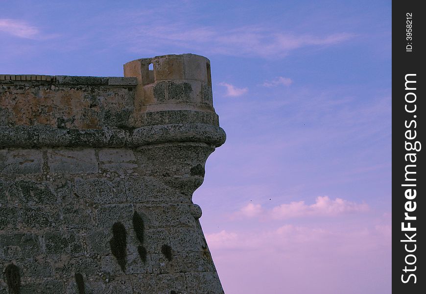 View of the wall of an old castle in the sunset. View of the wall of an old castle in the sunset