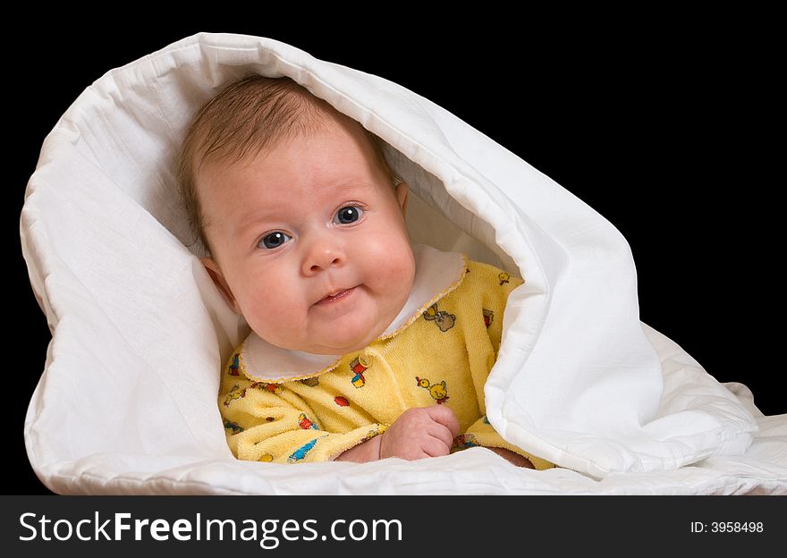 Baby in blanket over black background