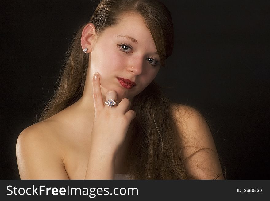 Portrait of the beautiful young girl on a black background. Portrait of the beautiful young girl on a black background.