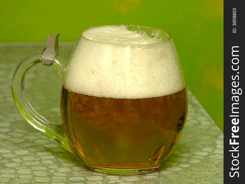Oval mug of fresh amber beer