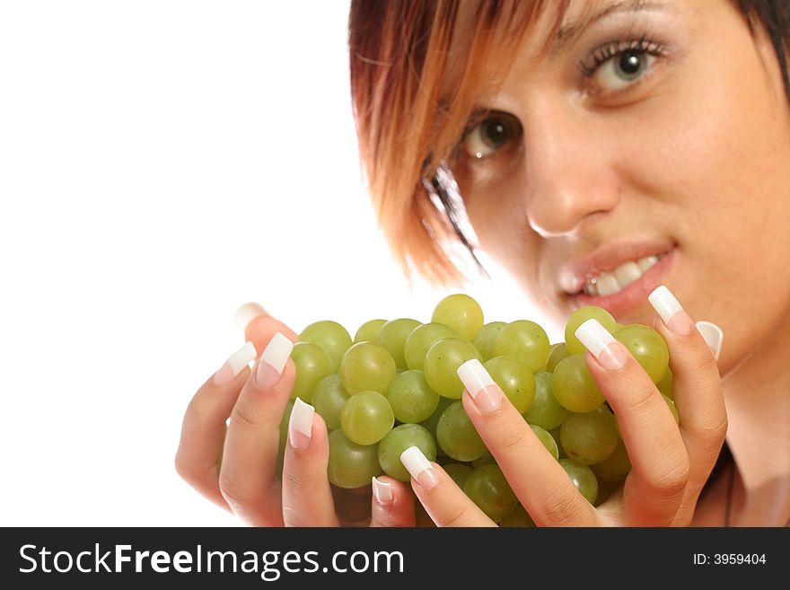 Beautiful girl with green grape on white