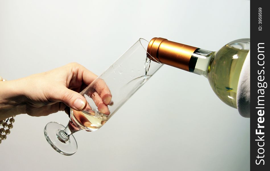 Hand of a man with a glass of white vine to toast. Hand of a man with a glass of white vine to toast.