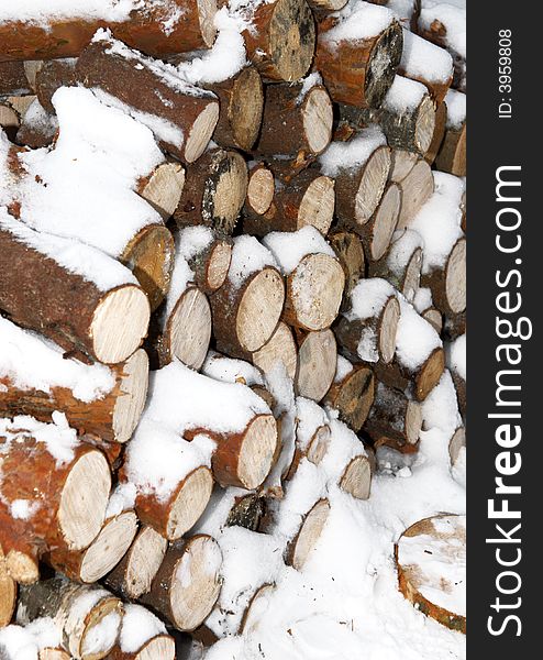 Woodpiles under snow in winter