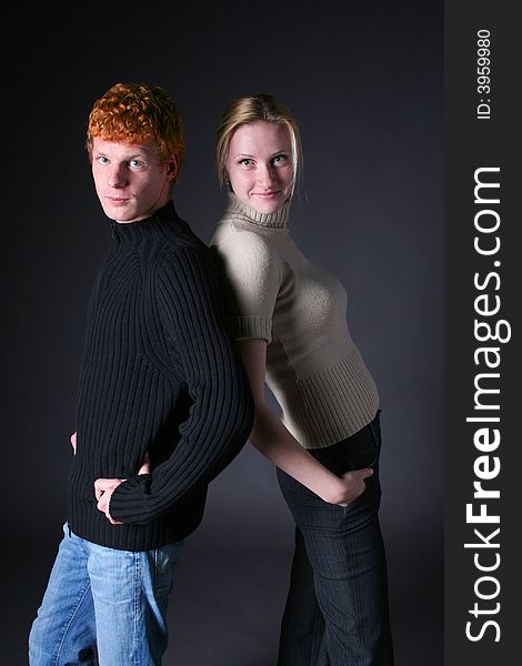 Blond girl and redhead boy on black background. Blond girl and redhead boy on black background
