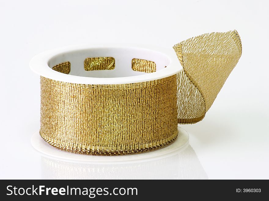 A spool of golden girft wrapping ribbon