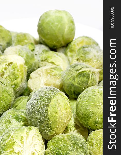 Frozen organic Brussel sprouts on bright background