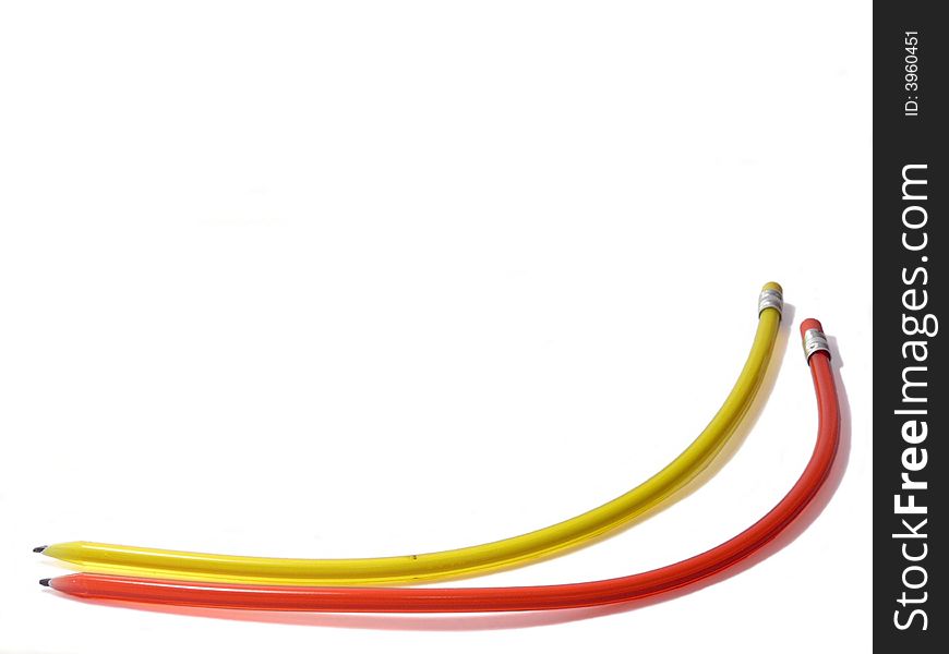 Two funny curved pencils. Red and yellow. Two funny curved pencils. Red and yellow