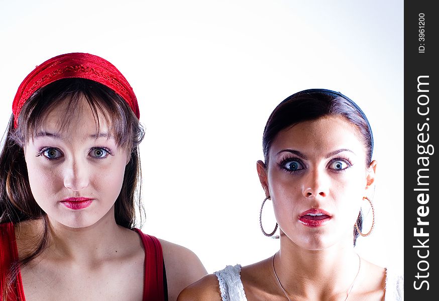 Two young women posing in the studio.