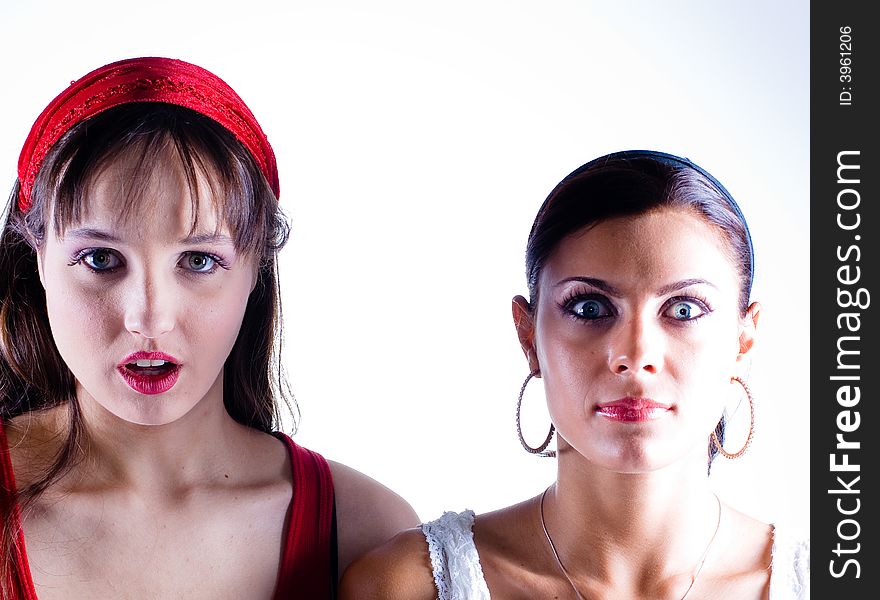 Two young women posing in the studio.