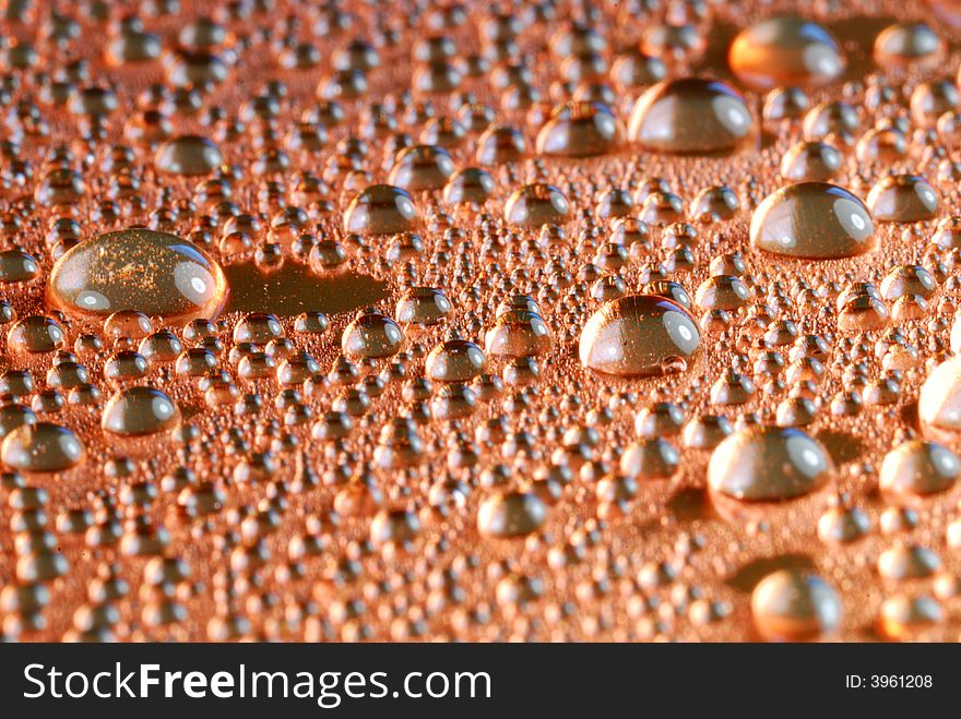 Copper colored water drops close up. Copper colored water drops close up