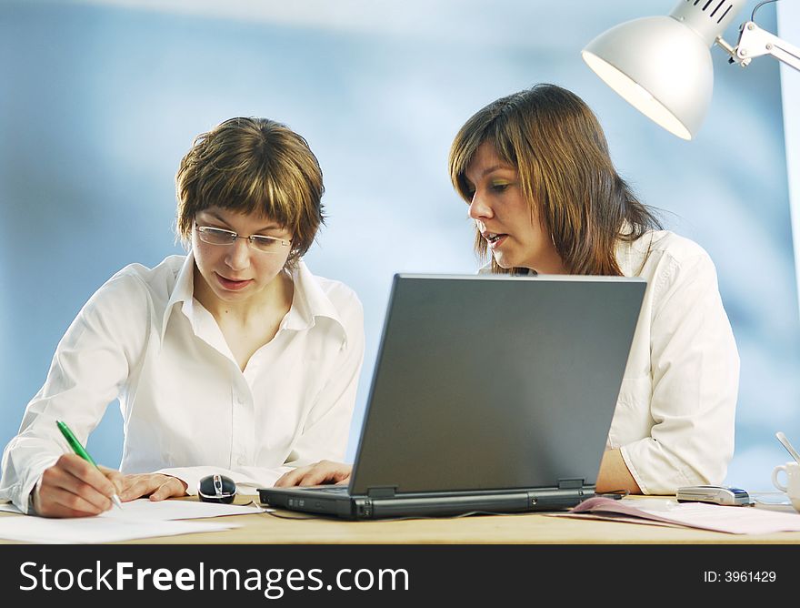 Misses with a notebook in an office