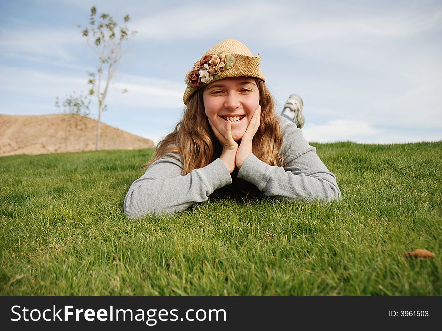 Young girl is enjoying herself in green field