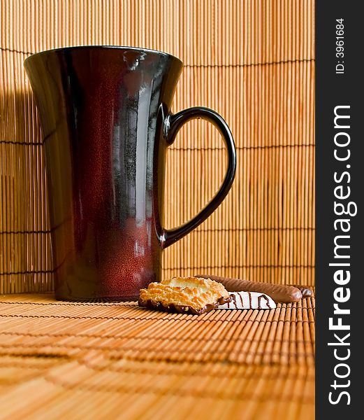Cup and cookies with bamboo background