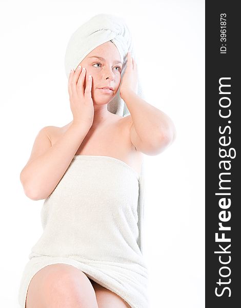 Studio portrait of a spa girl touching the towel on her head. Studio portrait of a spa girl touching the towel on her head