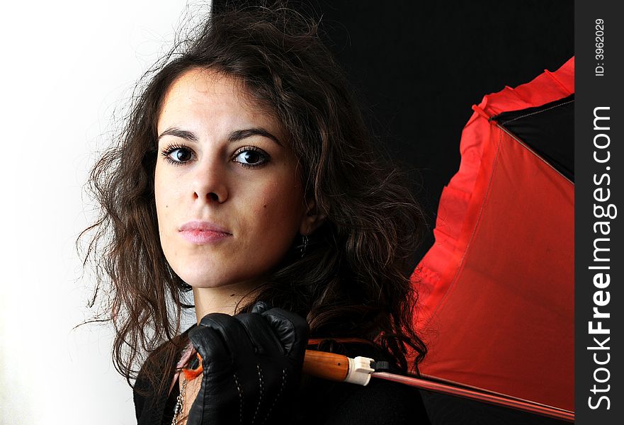 Beautiful brunette with umbrella on black background. Beautiful brunette with umbrella on black background