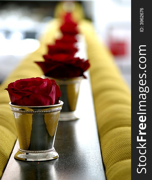 A row of roses in Sterling Silver cups