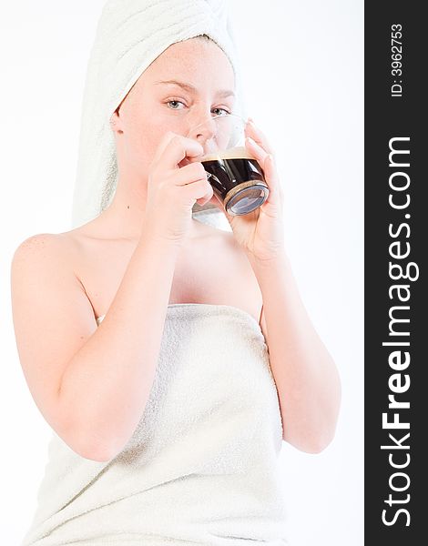 Studio portrait of a spa girl drinking coffee out of a glass. Studio portrait of a spa girl drinking coffee out of a glass