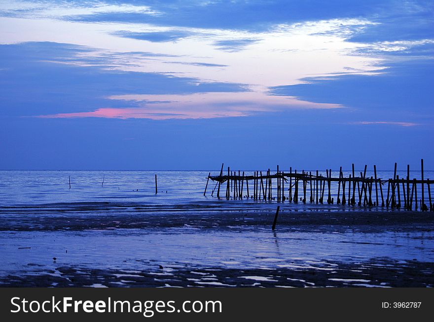 Beach, jetty and sea sunset.