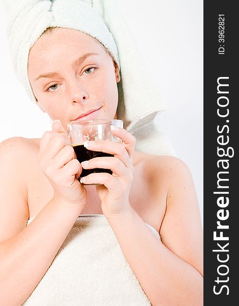 Studio portrait of a spa girl drinking coffee and waking up. Studio portrait of a spa girl drinking coffee and waking up