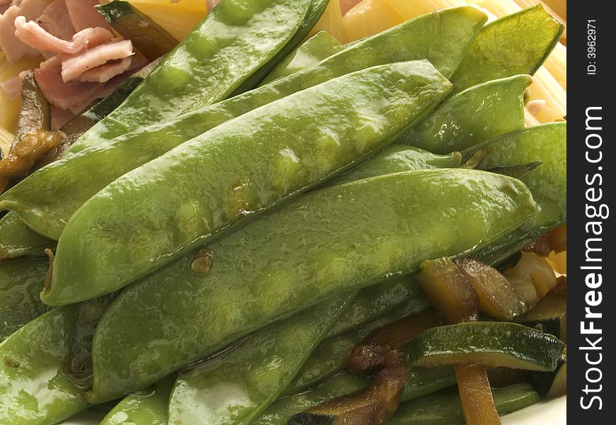 Closeup of boiled green pea pods on a plate. Closeup of boiled green pea pods on a plate