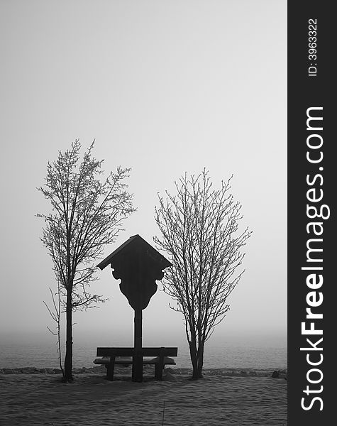 Winter meditation in bavaria, trees, bench and religious sign