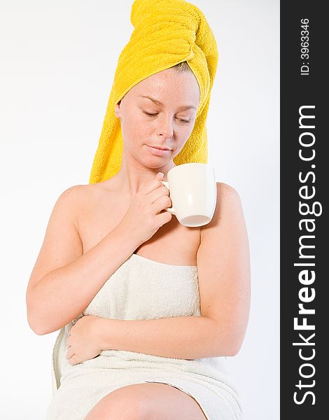 Studio portrait of a spa girl looking into her coffee. Studio portrait of a spa girl looking into her coffee