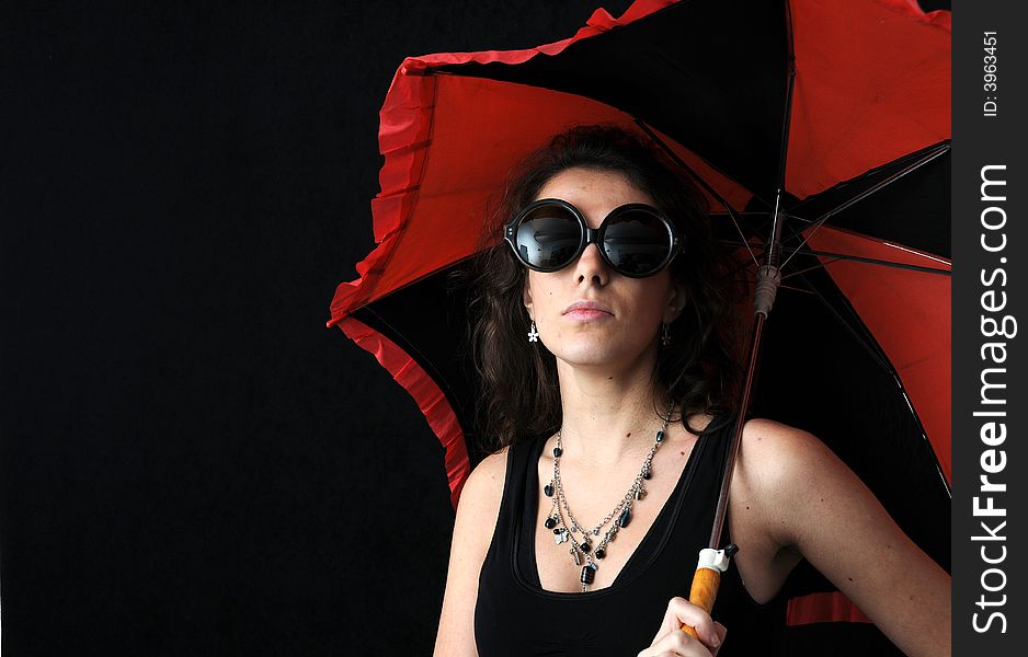 Beautiful brunette with umbrella on black background. Beautiful brunette with umbrella on black background