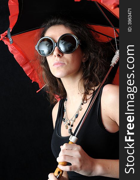 Beautiful brunette with umbrella on black background. Beautiful brunette with umbrella on black background