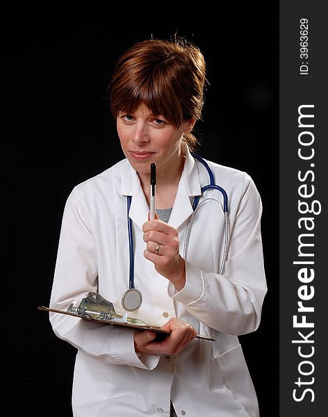 Attractive young lady doctor in white coat with stethosope lecturing a patient - on black background. Attractive young lady doctor in white coat with stethosope lecturing a patient - on black background