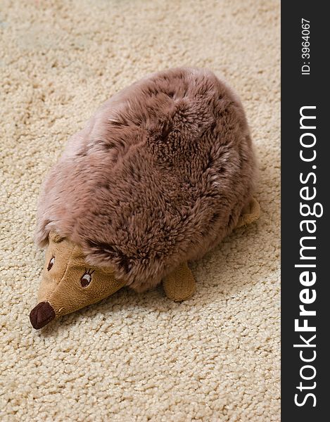 Photo of toy hedgehogs sitting on the beige carpet