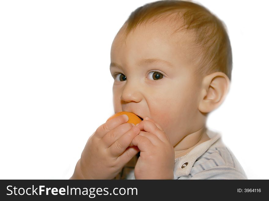 Baby boy eating orange, isolated over white