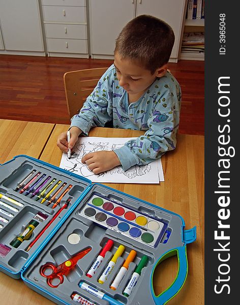 A child is coloring a picture with crayons