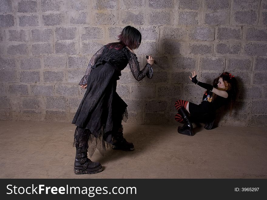 The girl in Gothic style attacks a defenceless victim