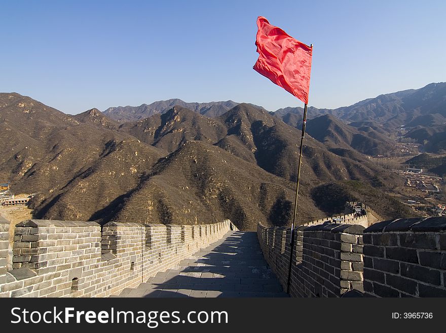 View of the Great Wall of China with red flag and blue sky. View of the Great Wall of China with red flag and blue sky