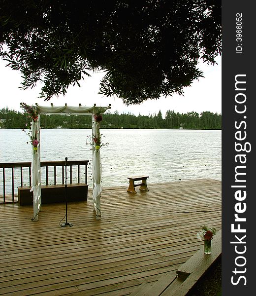 A wooden dock set up for an outdoor wedding. A wooden dock set up for an outdoor wedding.