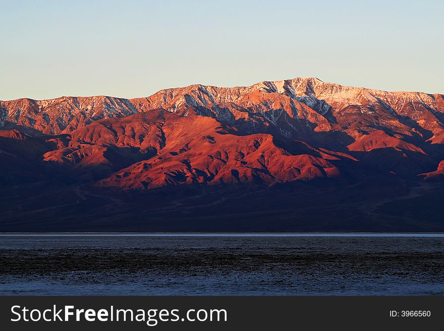 Snow speckled mountain peak in Death Valley at sunrise. Snow speckled mountain peak in Death Valley at sunrise.